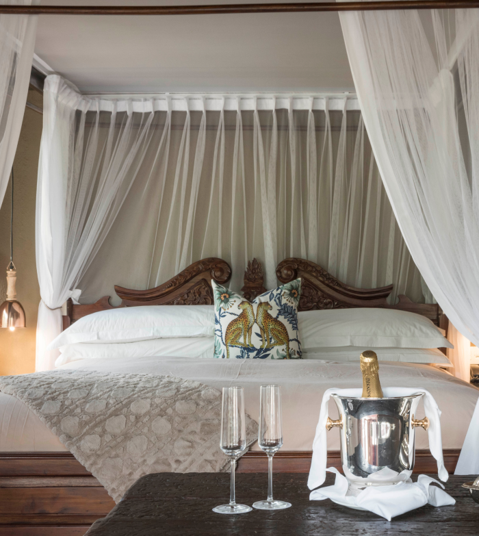 Luxurious bedroom offering unparalleled comfort and elegance in tranquil Camp Ndlovu.