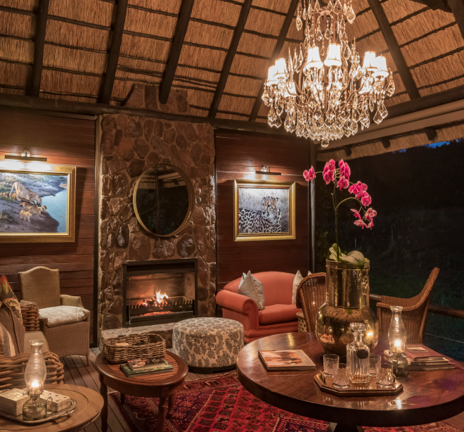 Lodge outdoor seating area providing panoramic views of the lush African landscape.