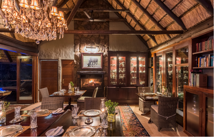 Cosy indoor dining at Camp Ndlovu, offering exquisite meals in comfortable setting.