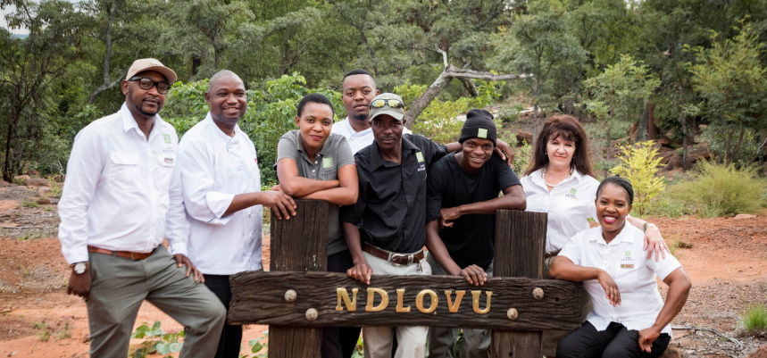 Outdoor group photo capturing camaraderie and dedication of the Camp Ndlovu staff.