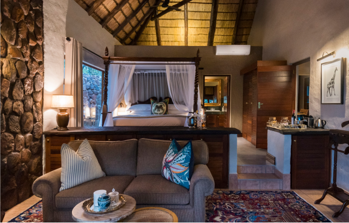 Luxury bedroom in malaria-free game lodge, providing comfort amidst nature's grandeur.