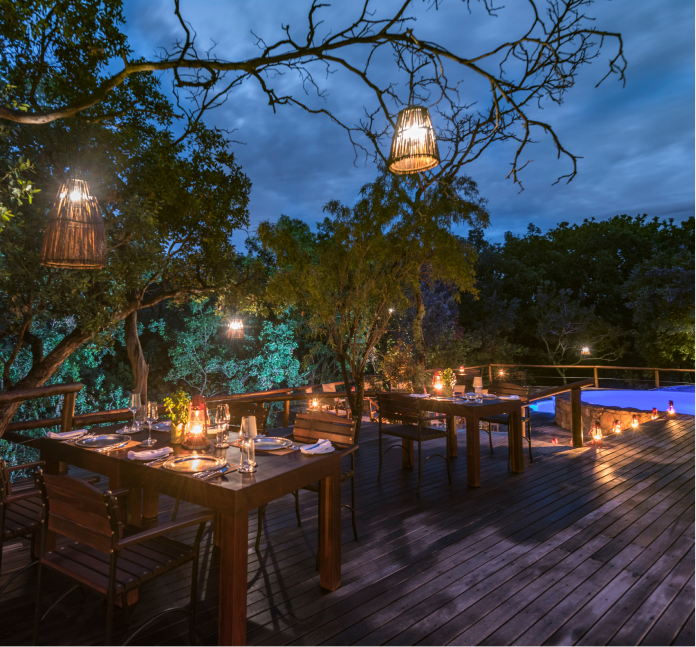 Enjoy warmth of African sun from outdoor seating area with a pool in the bush.